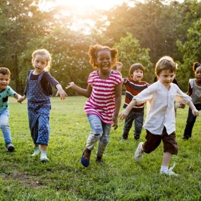 Group of Diverse Kids Playing at the Field Together